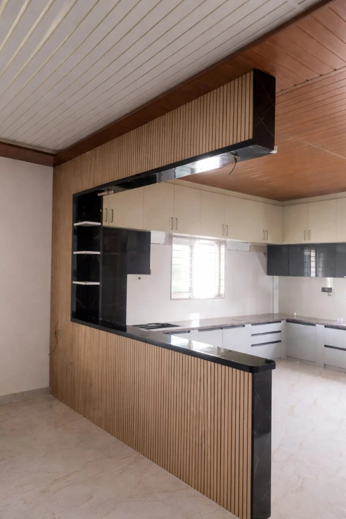 Modern modular kitchen and overhead wooden cabinets featuring warm LED profile lighting