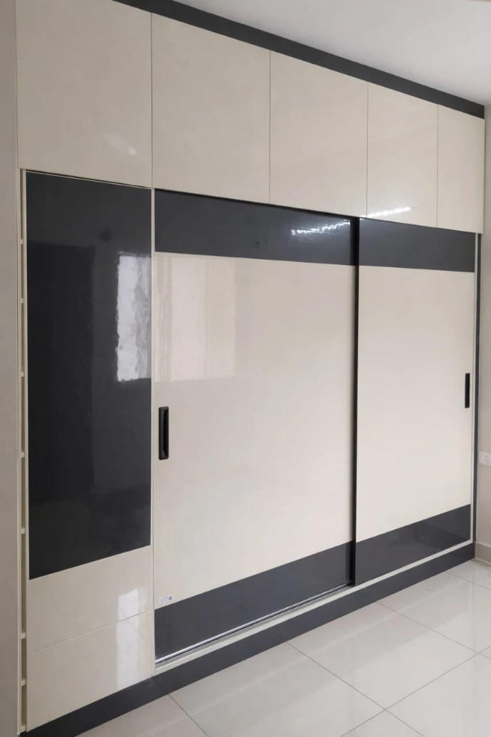 Sleek sliding door wardrobe in black and white finish for contemporary bedrooms